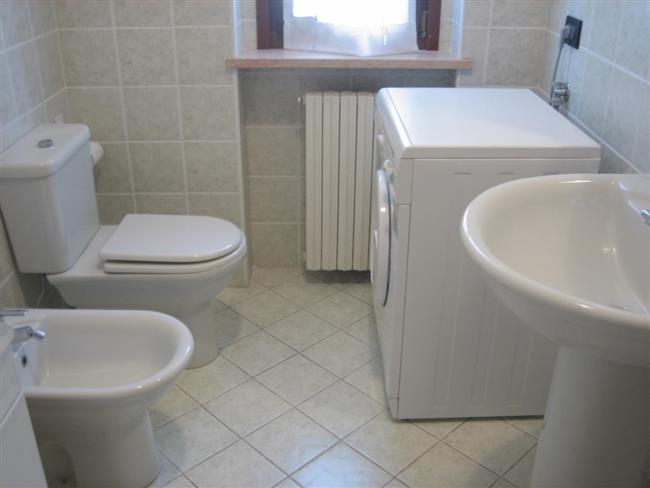 bathroom with shower and washing machine