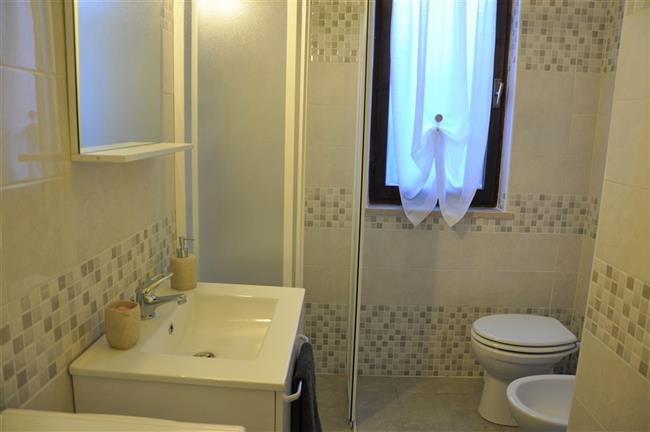 bathroom with shower and washing machine