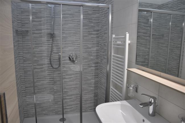 bathroom with shower and washing machine