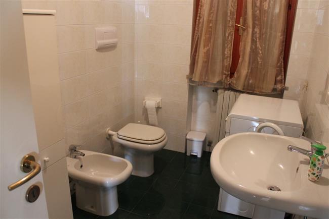 bathroom with shower and washing machine