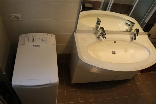 bathroom with shower and washing machine