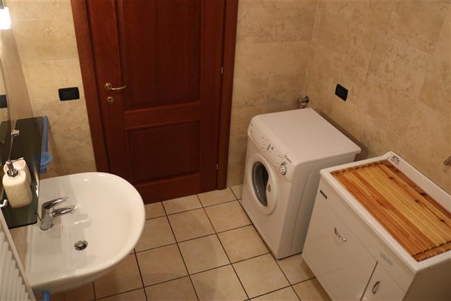 bathroom with shower and washing machine